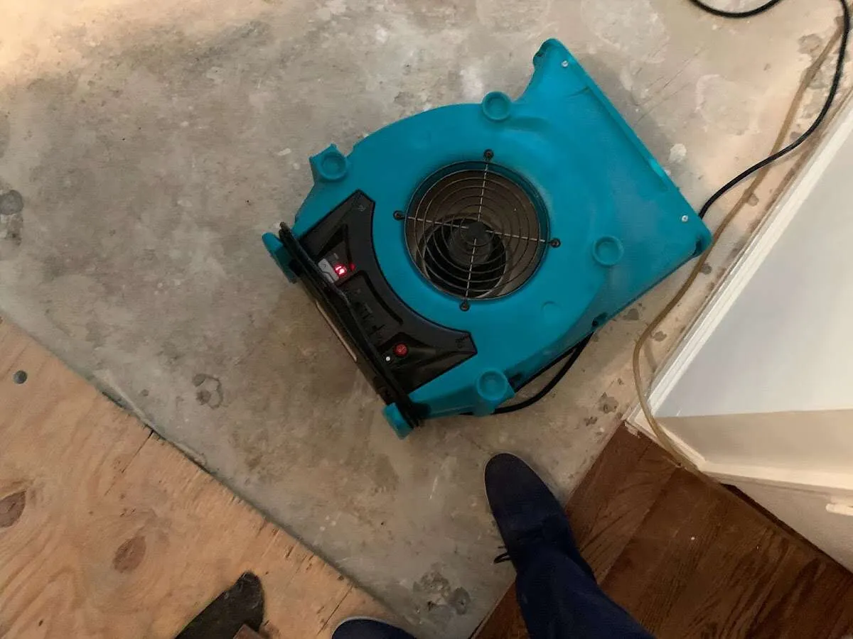 Air mover drying subfloor during Commercial Water Damage Restoration in Big Stone Gap
